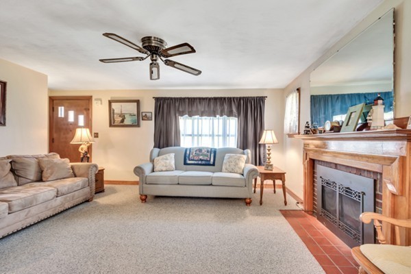 11 Melo Road Woburn, MA 01801 - Photo 10 of 22 a living room with furniture and a fireplace