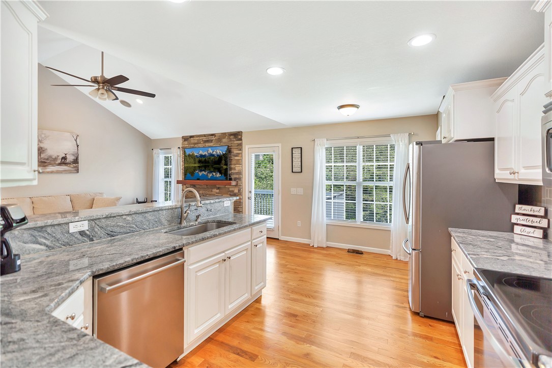 131 Morgan Road West Union, SC 29696 - Photo 9 of 39 A well-lit kitchen with granite countertops, stainless steel appliances, and a seamless flow into the living area.
