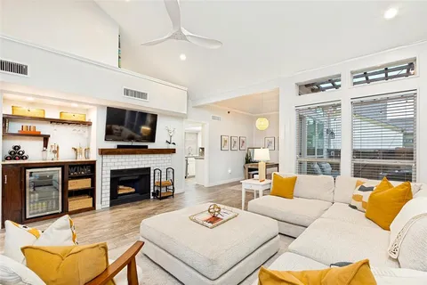 a living room with furniture fireplace and a flat screen tv