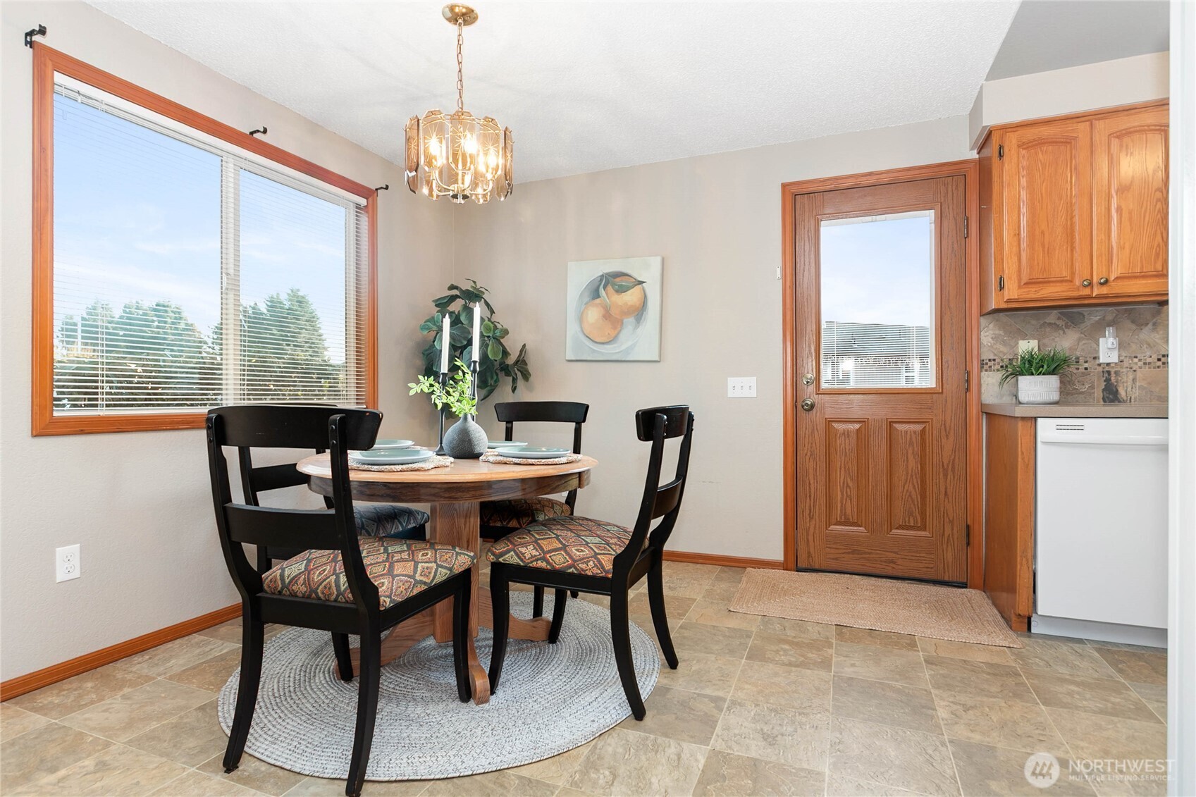 508 Forest Circle, Unit 4A Lynden, WA 98264 - Photo 11 of 25 a dining room with furniture a rug a potted plant and a chandelier