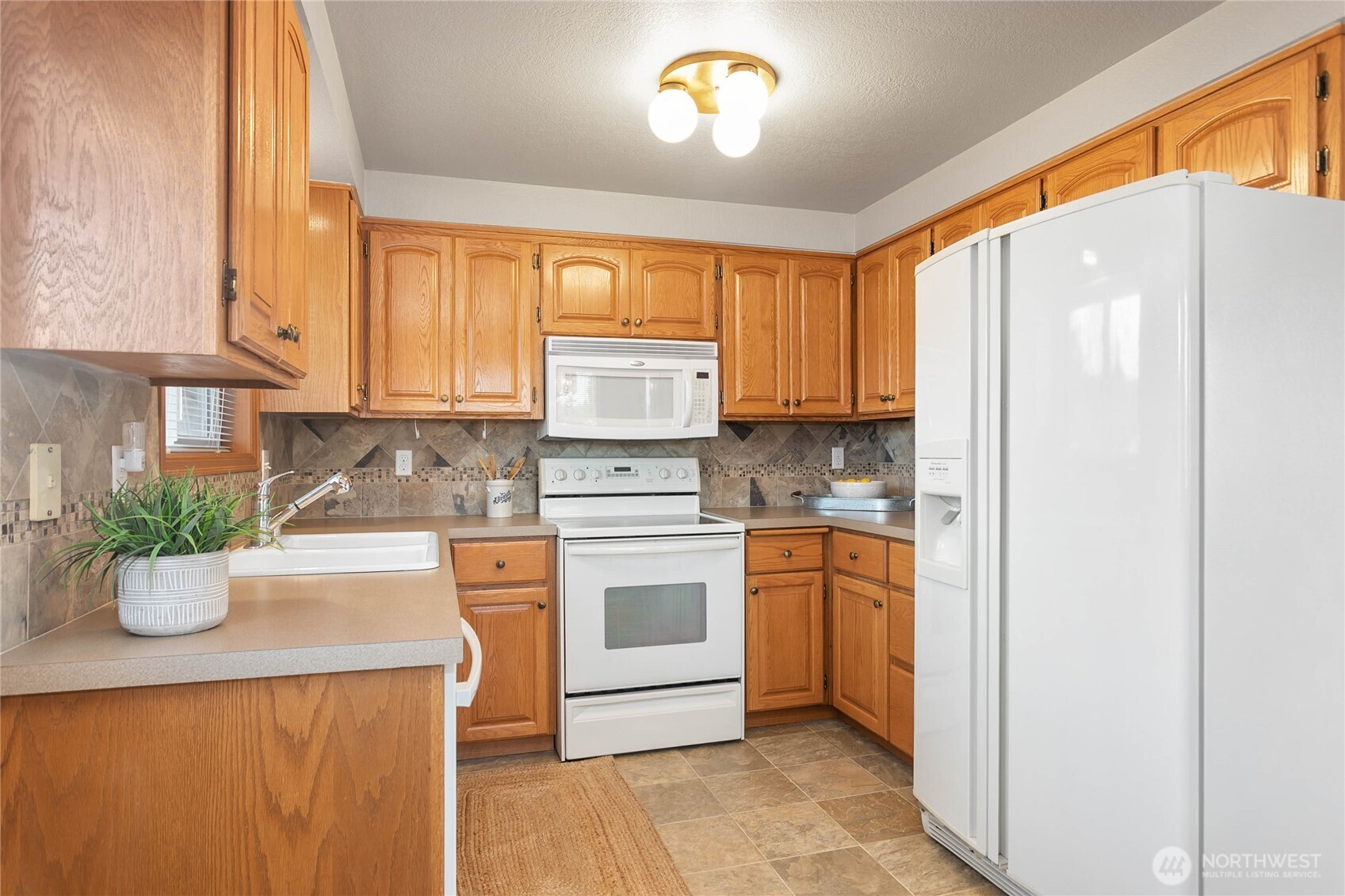 508 Forest Circle, Unit 4A Lynden, WA 98264 - Photo 14 of 25 a kitchen with a refrigerator and cabinets