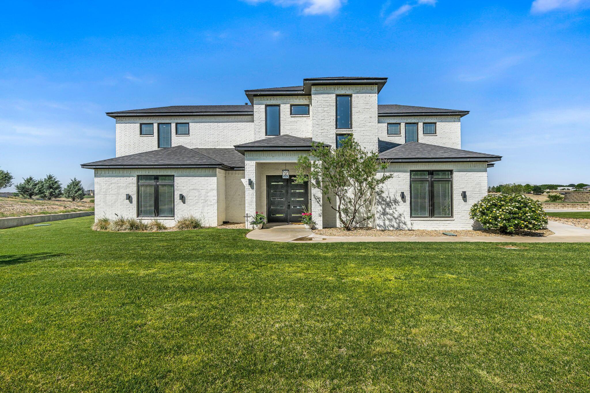 17400 Spring Lake Drive Canyon, TX 79015 - Photo 1 of 52 a front view of a house with a garden