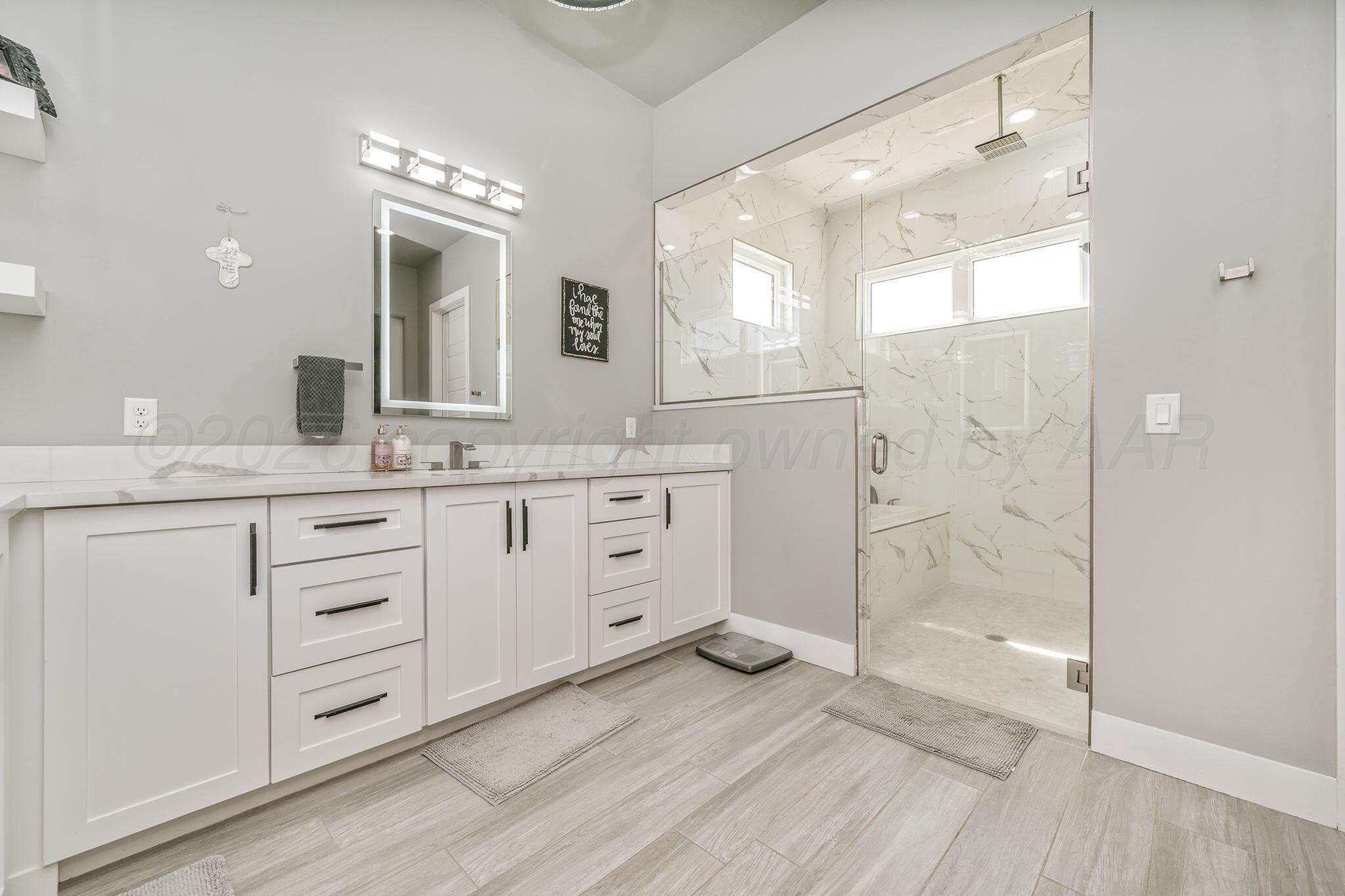 17400 Spring Lake Drive Canyon, TX 79015 - Photo 16 of 52 a bathroom with a granite countertop sink mirror and shower