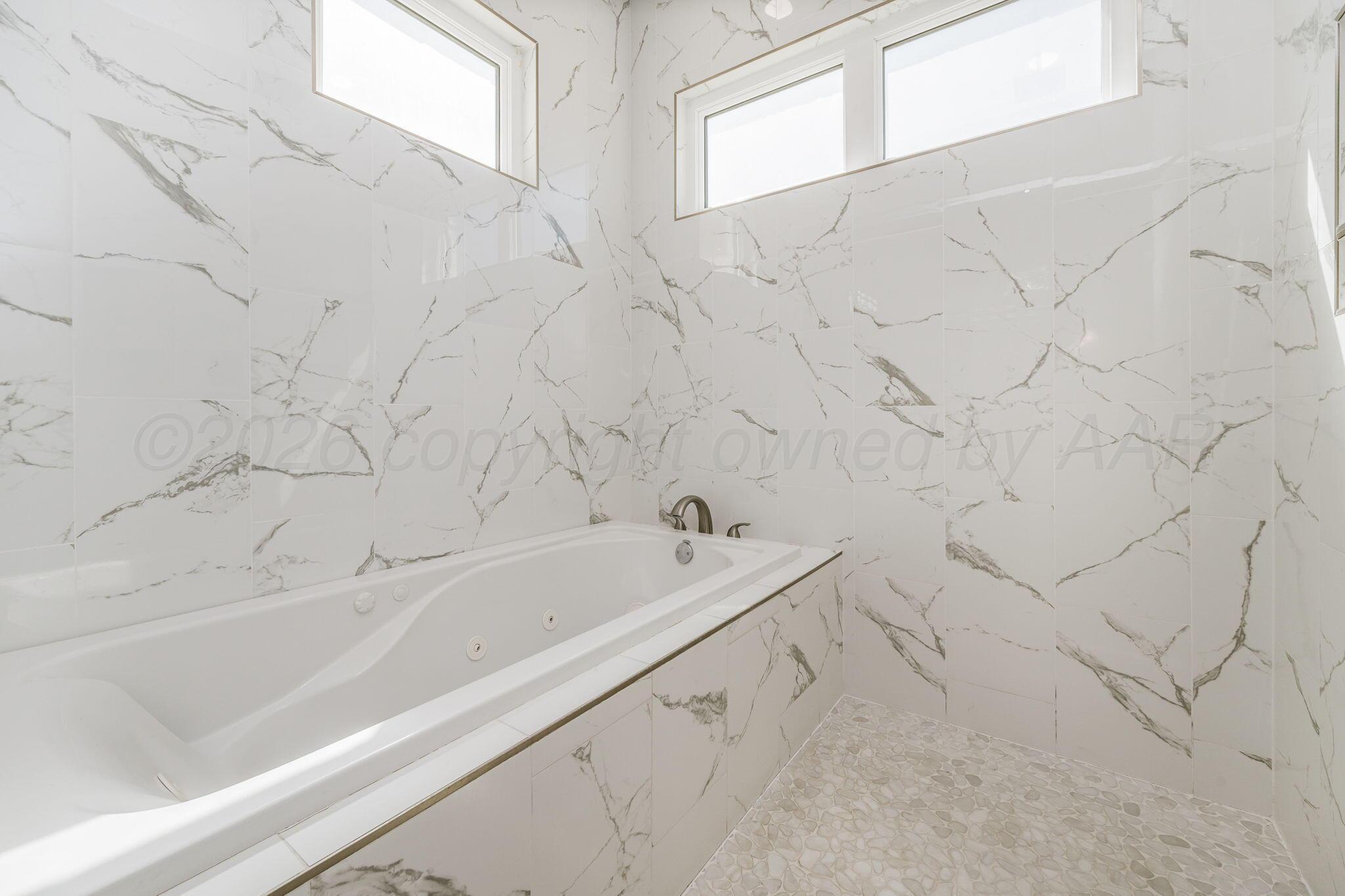 17400 Spring Lake Drive Canyon, TX 79015 - Photo 17 of 52 a bathroom with bathtub and window