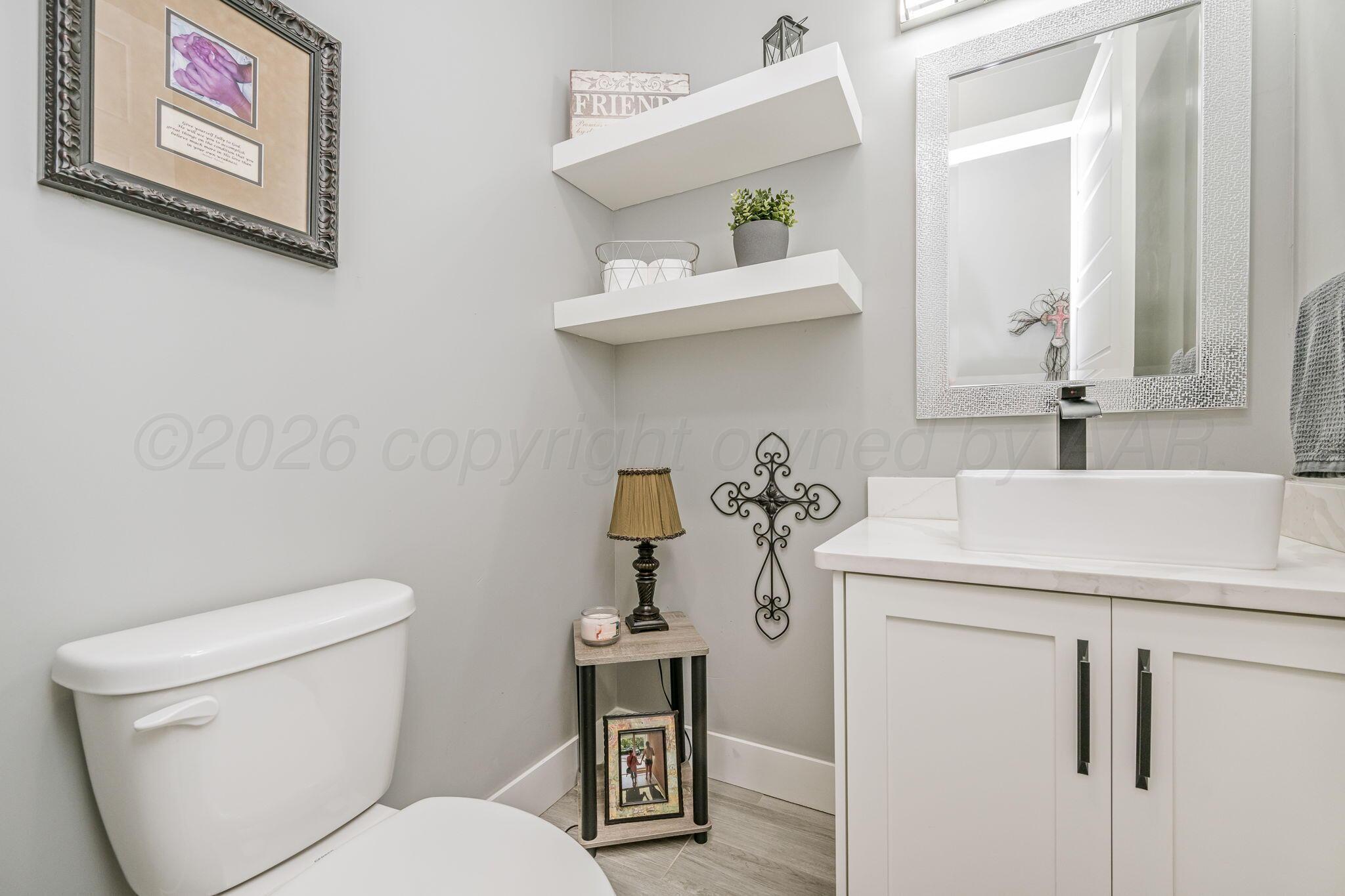 17400 Spring Lake Drive Canyon, TX 79015 - Photo 19 of 52 a bathroom with a sink a toilet and vanity
