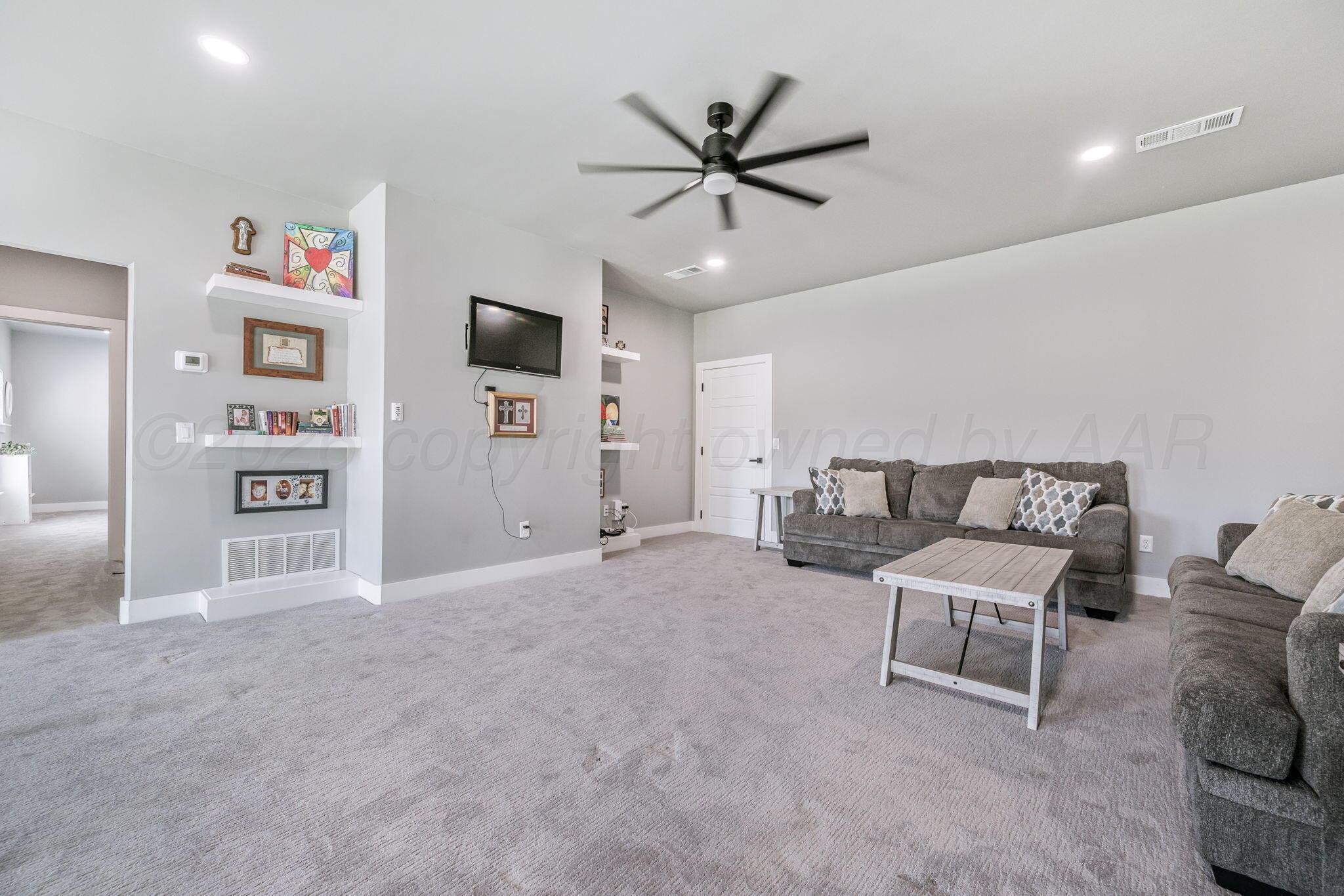 17400 Spring Lake Drive Canyon, TX 79015 - Photo 21 of 52 a living room with furniture and a flat screen tv