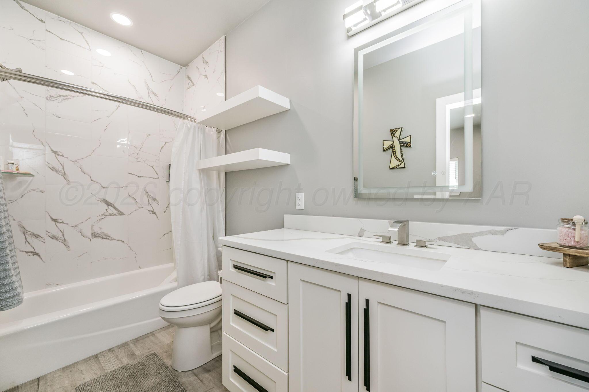 17400 Spring Lake Drive Canyon, TX 79015 - Photo 23 of 52 a bathroom with a sink toilet vanity and shower