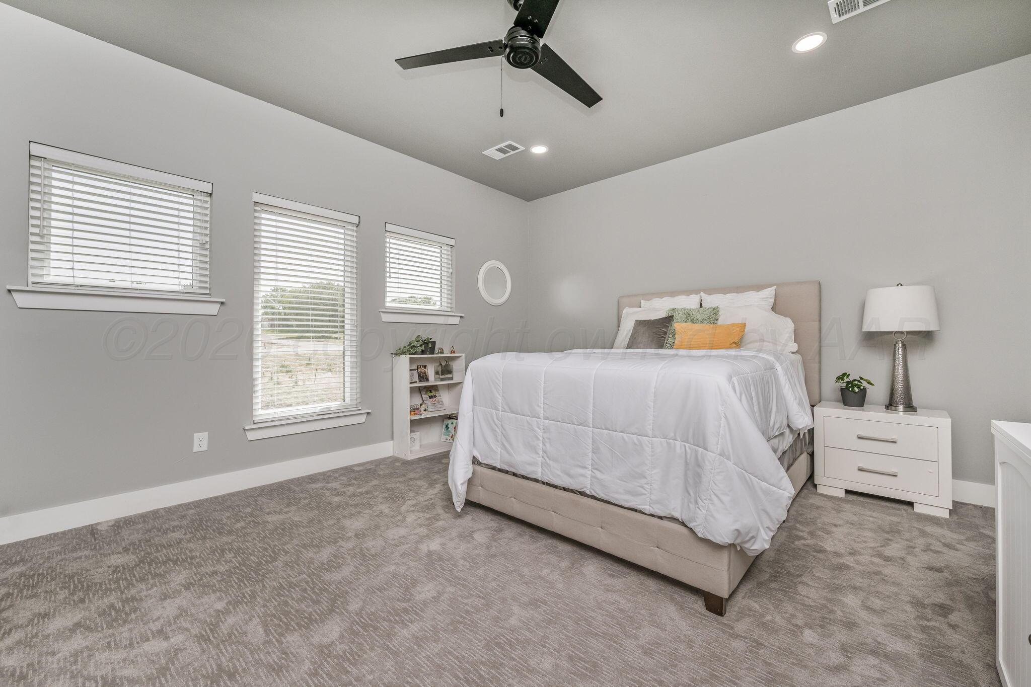 17400 Spring Lake Drive Canyon, TX 79015 - Photo 24 of 52 a bedroom with a bed and a large window