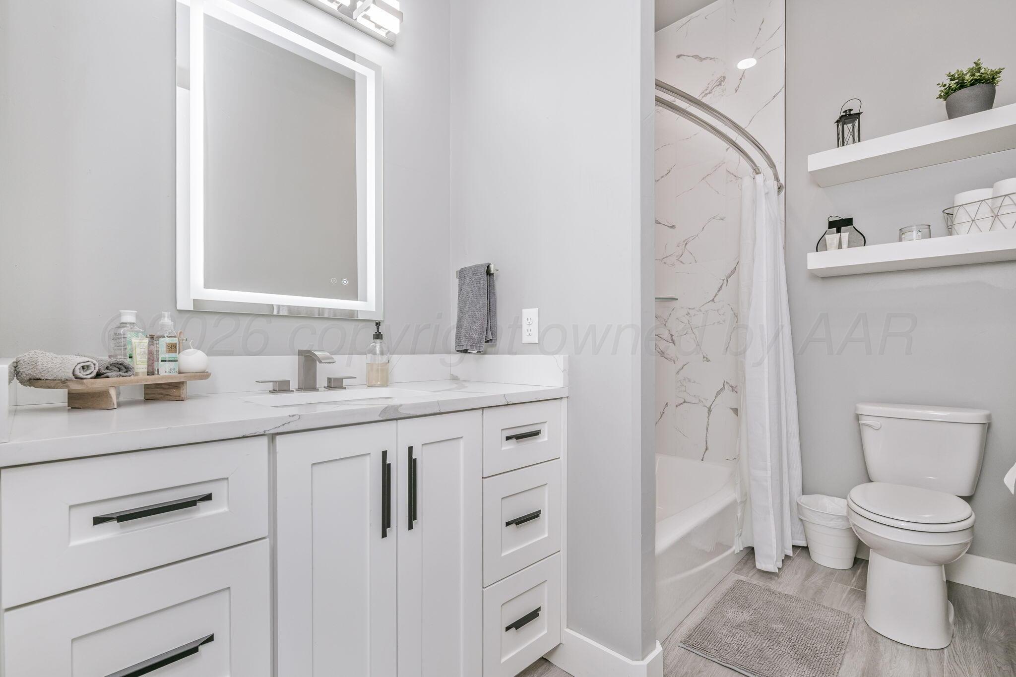 17400 Spring Lake Drive Canyon, TX 79015 - Photo 25 of 52 a bathroom with a granite countertop sink toilet and shower