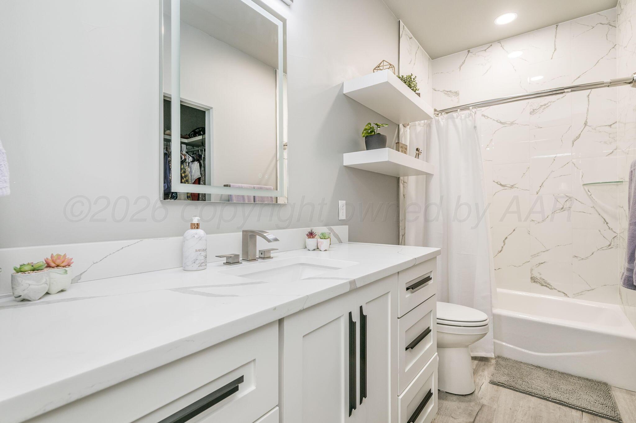 17400 Spring Lake Drive Canyon, TX 79015 - Photo 27 of 52 a bathroom with a sink a toilet and shower
