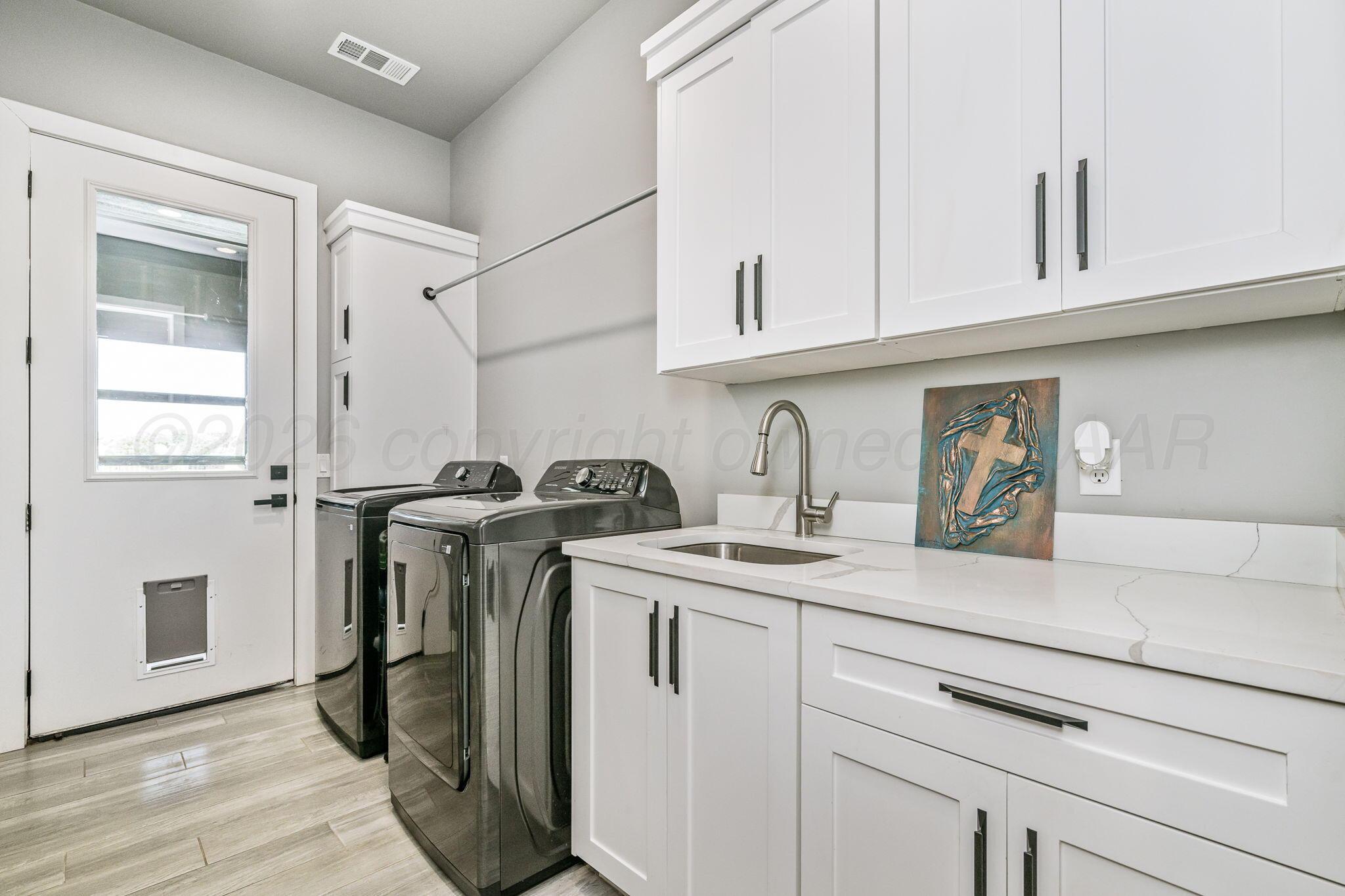 17400 Spring Lake Drive Canyon, TX 79015 - Photo 29 of 52 a utility room with cabinets washer and dryer