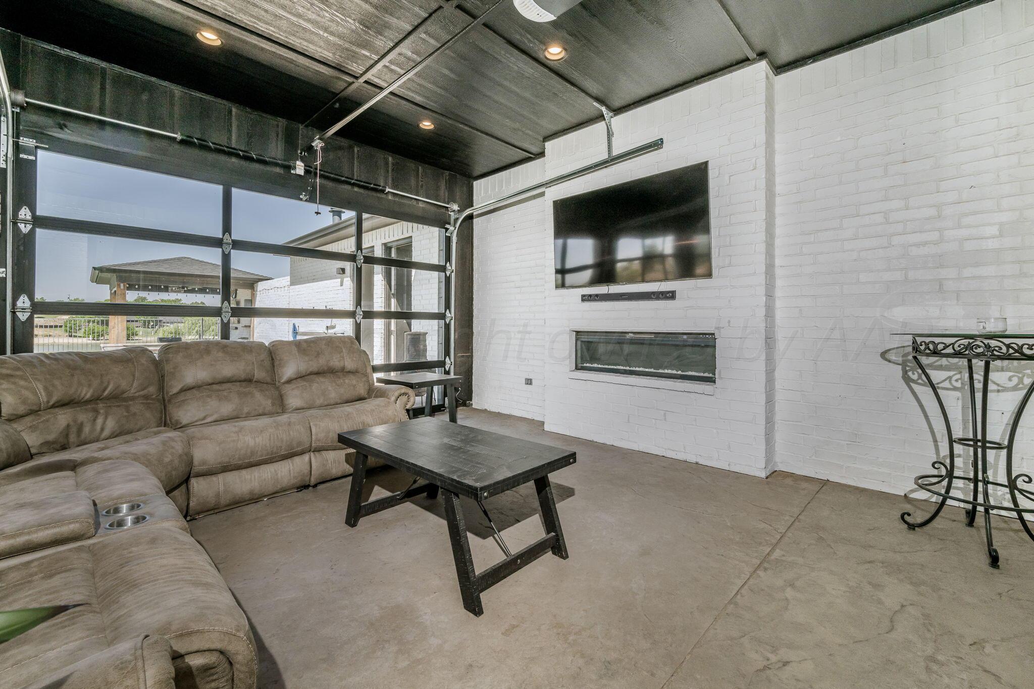 17400 Spring Lake Drive Canyon, TX 79015 - Photo 32 of 52 a living room with furniture and a flat screen tv