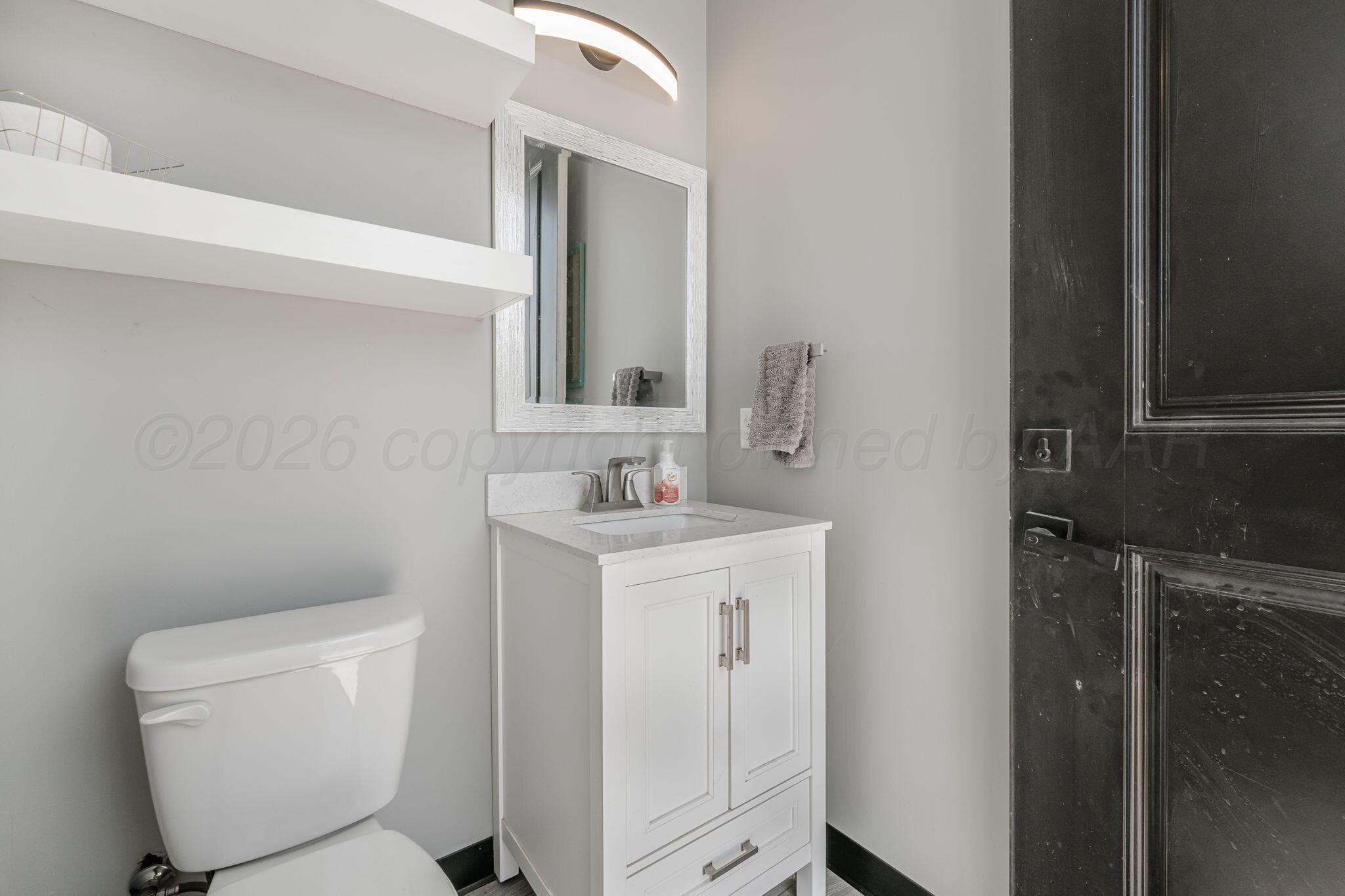 17400 Spring Lake Drive Canyon, TX 79015 - Photo 39 of 52 a bathroom with a toilet sink and mirror