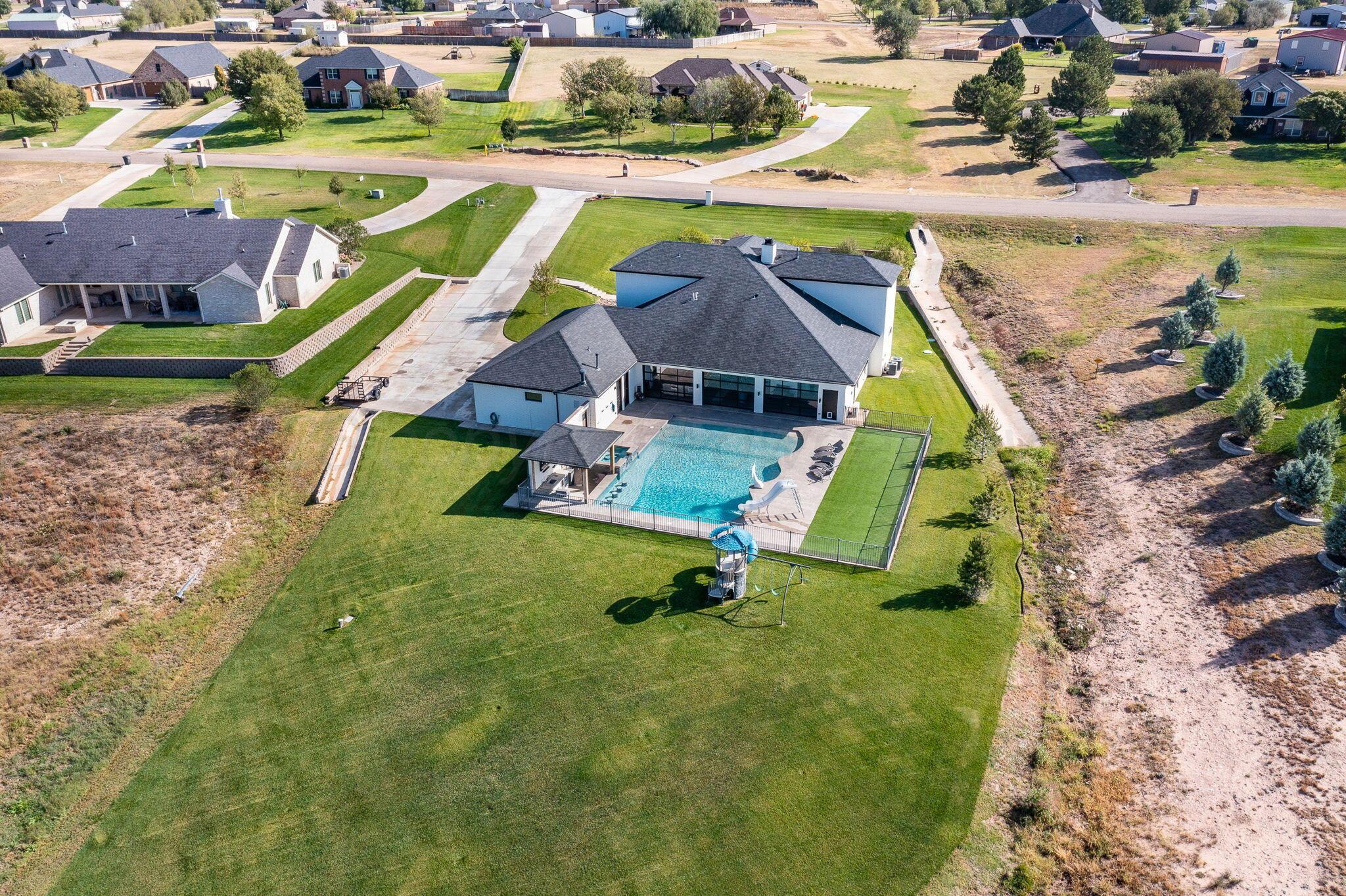 17400 Spring Lake Drive Canyon, TX 79015 - Photo 43 of 52 an aerial view of a swimming pool with a yard and lake view