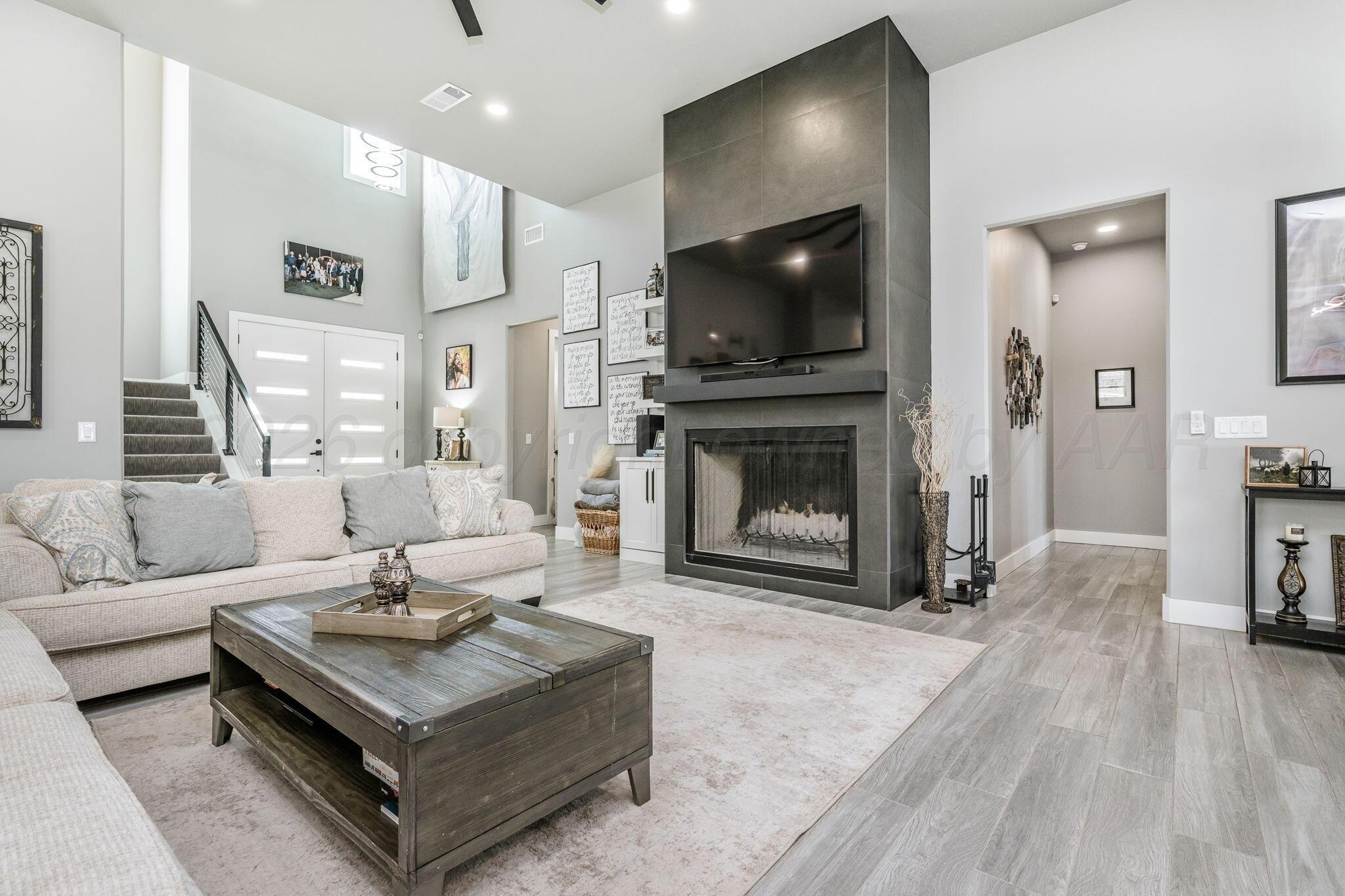 17400 Spring Lake Drive Canyon, TX 79015 - Photo 6 of 52 a living room with furniture a flat screen tv and a fireplace