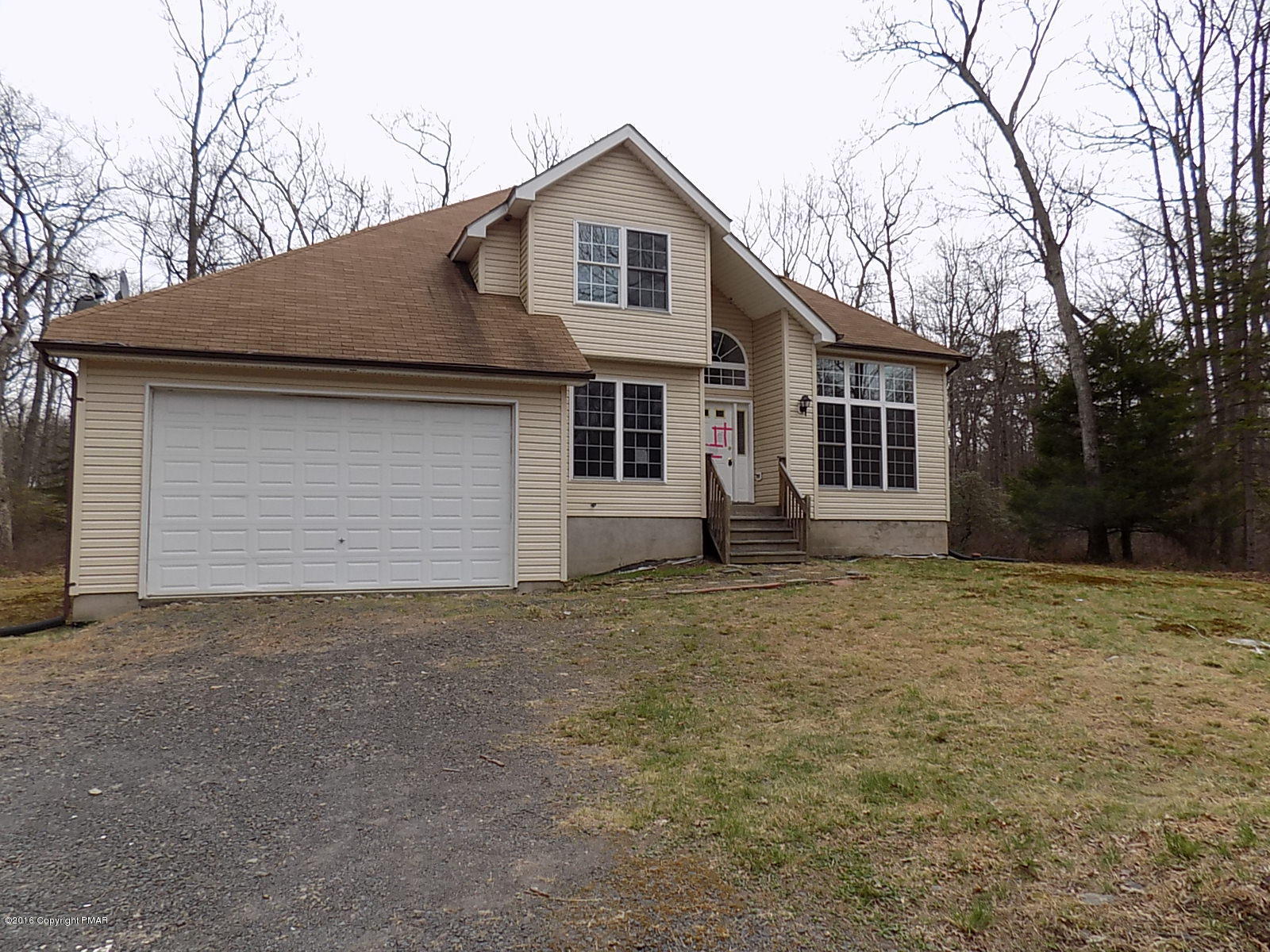 266 Oneida Way Milford, PA 18337 - Photo 1 of 22 a front view of a house with a yard and garage
