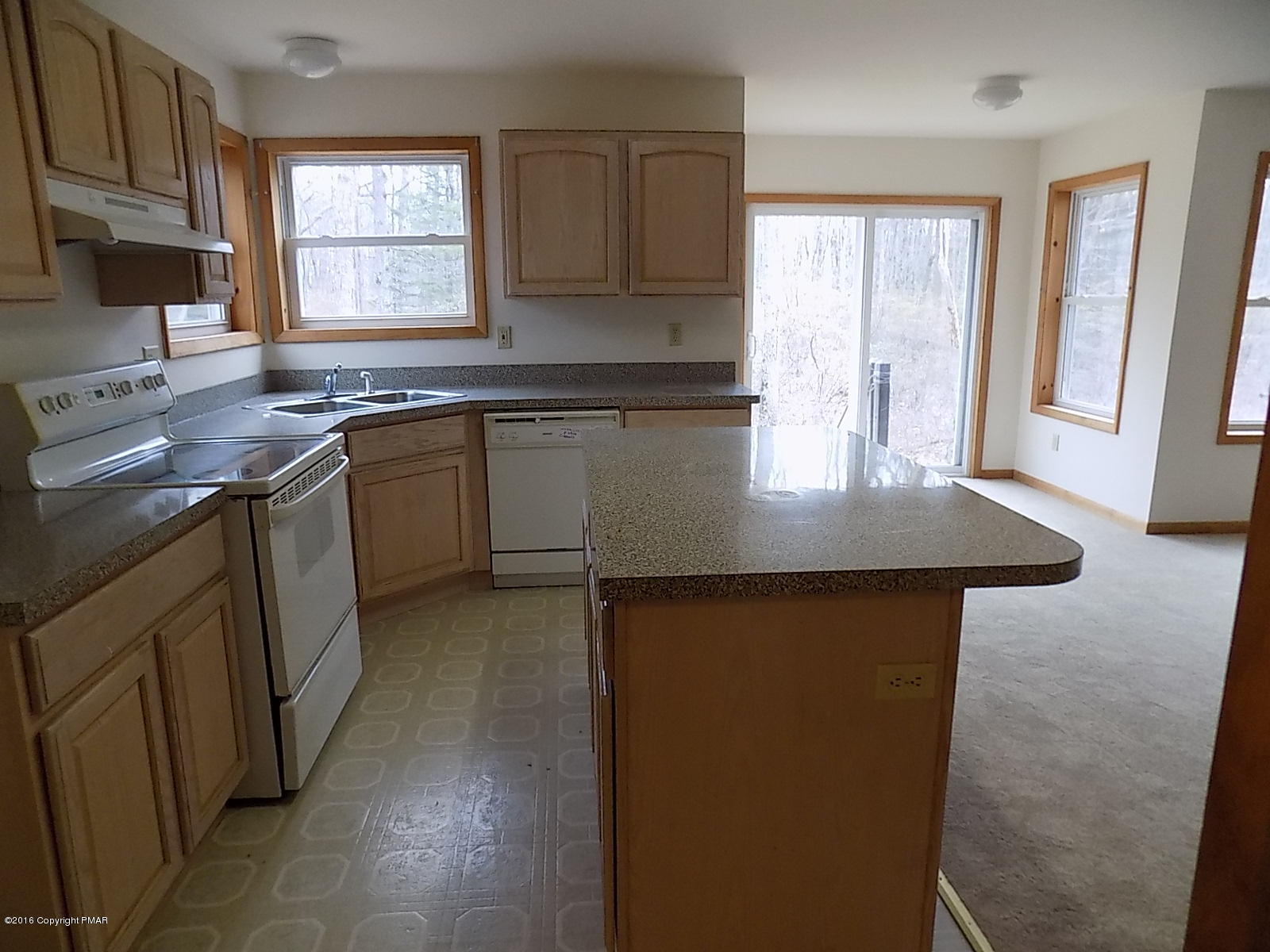 266 Oneida Way Milford, PA 18337 - Photo 12 of 22 a kitchen with kitchen island granite countertop a sink window and cabinets