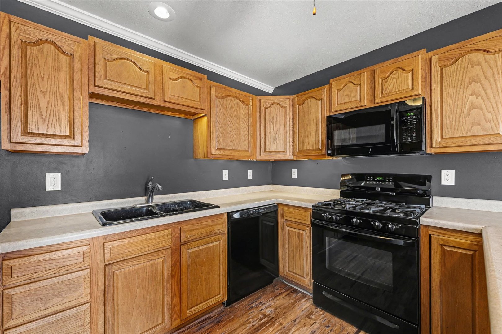 306 B W Lytle Street Newman, IL 61942 - Photo 11 of 47 a kitchen with stainless steel appliances granite countertop a sink stove microwave and cabinets