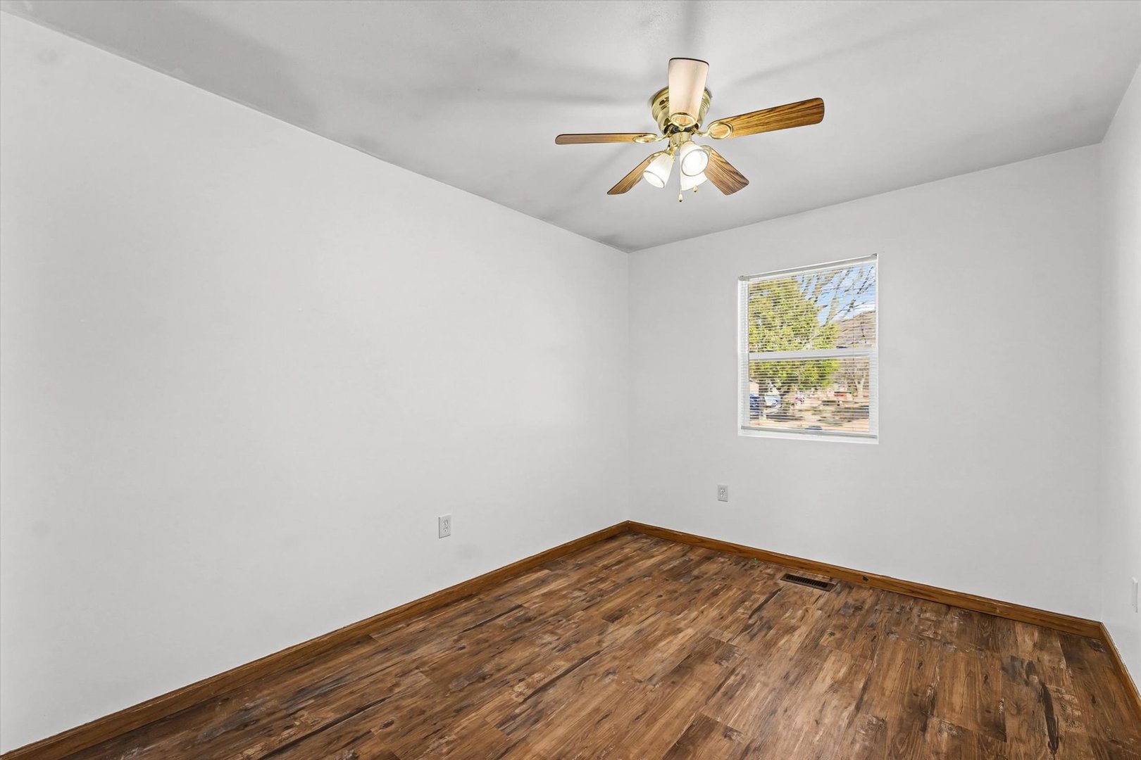 306 B W Lytle Street Newman, IL 61942 - Photo 19 of 47 wooden floor in an empty room with a window