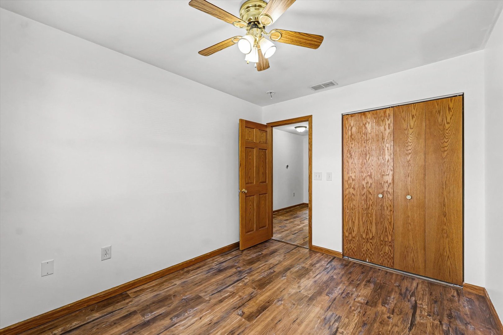 306 B W Lytle Street Newman, IL 61942 - Photo 20 of 47 an empty room with closet and chandelier fan