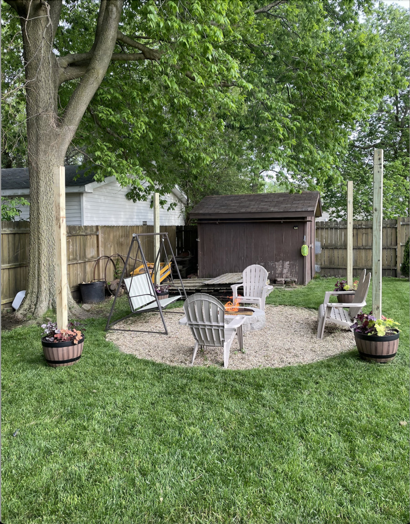 306 B W Lytle Street Newman, IL 61942 - Photo 31 of 47 a view of a backyard with table and chairs potted plants and a large tree