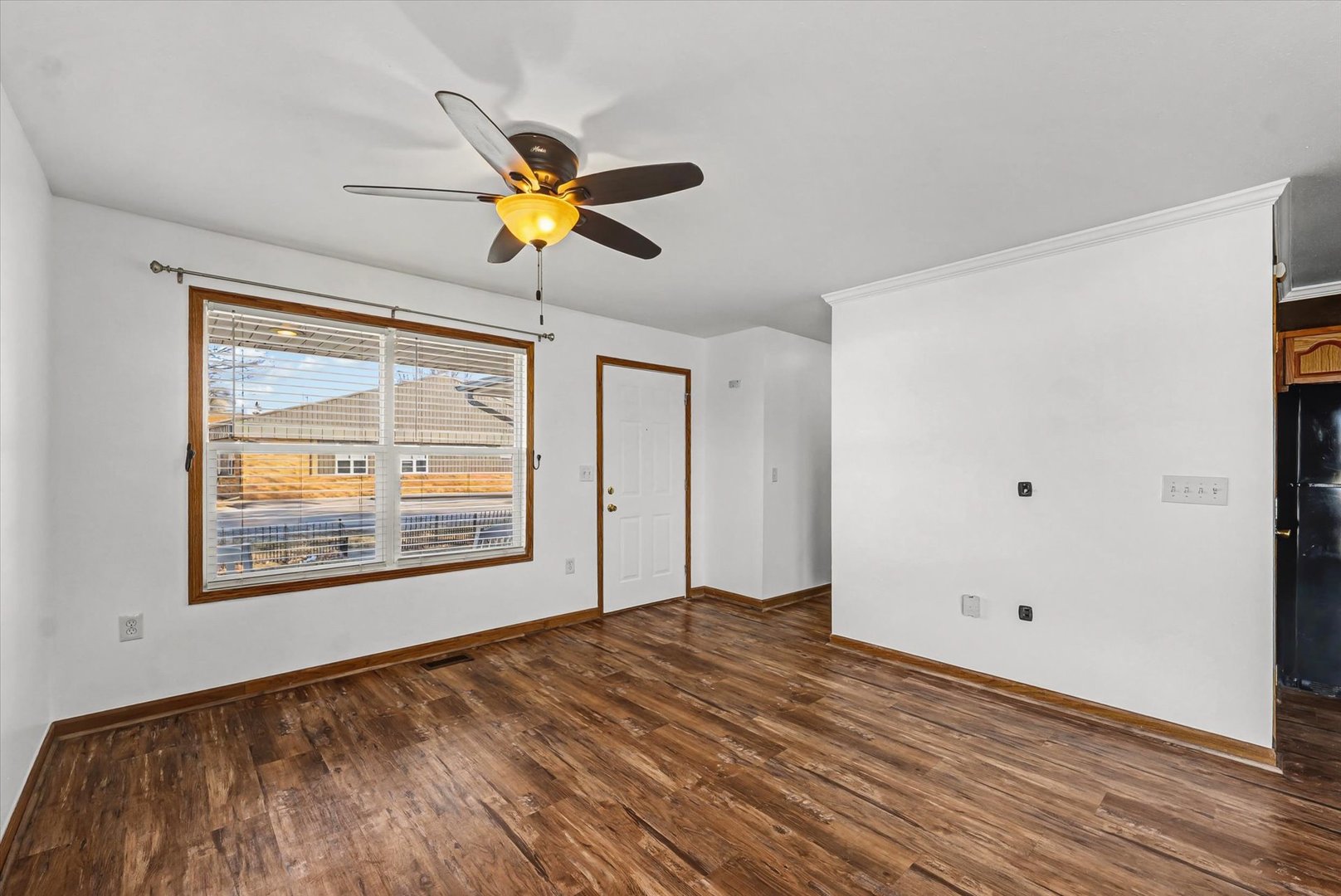 306 B W Lytle Street Newman, IL 61942 - Photo 8 of 47 a view of empty room with wooden floor and fan