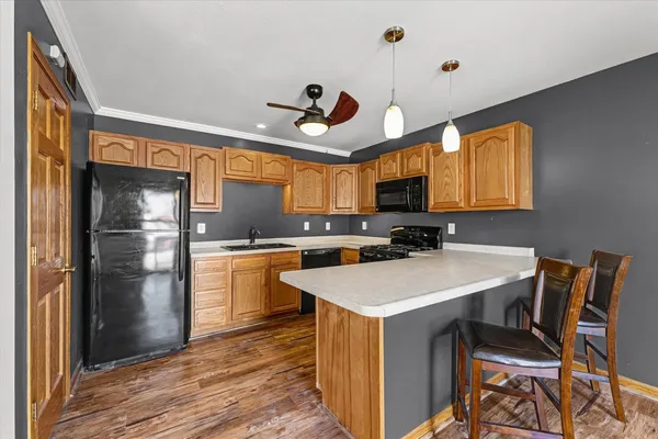 a kitchen with a sink a refrigerator and window