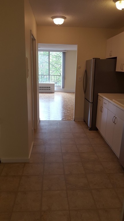 44 Washington Street, Unit 411 Brookline, MA 02445 - Photo 7 of 23 a view of a kitchen with refrigerator and window