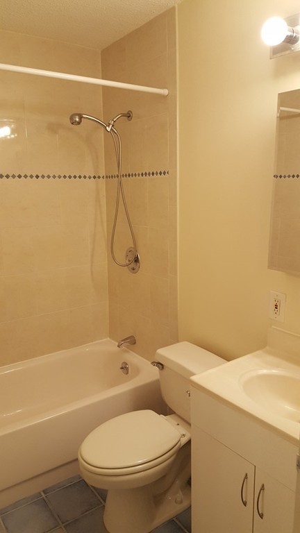 44 Washington Street, Unit 411 Brookline, MA 02445 - Photo 8 of 23 a bathroom with a toilet sink and shower