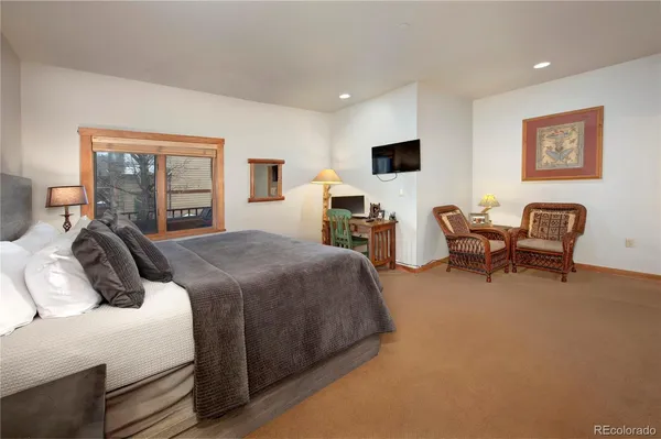 a bedroom with two beds and a couch