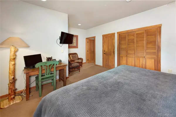 a bedroom with a bed and flat screen tv