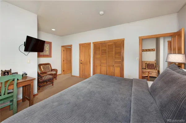 a bedroom with furniture and a flat screen tv