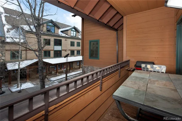 a view of a balcony with two chairs and a table