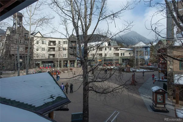 a view of a building with cars