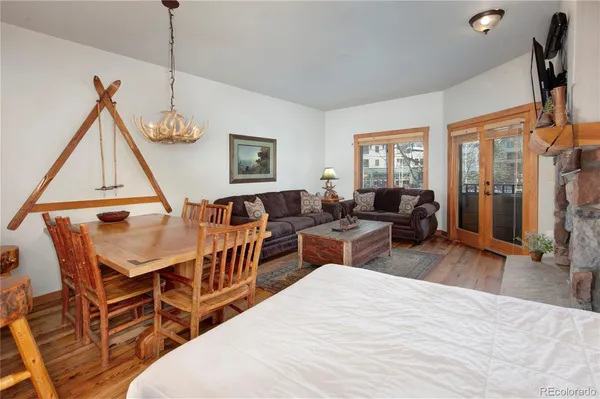 a living room with furniture a window and a wooden floor