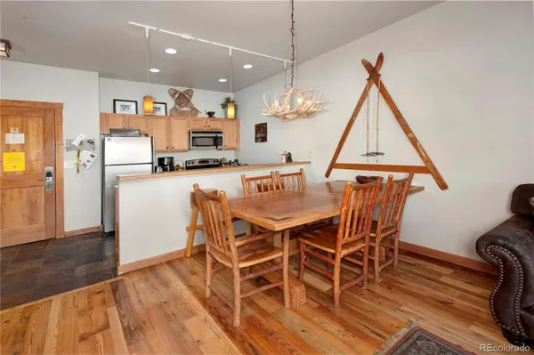 a dining room with furniture and wooden floor