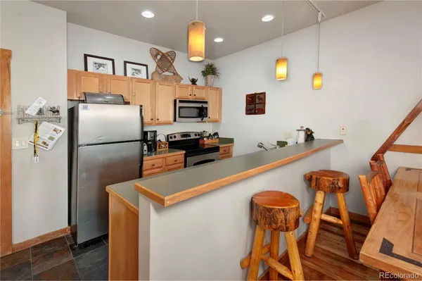 a kitchen with stainless steel appliances a refrigerator and a stove