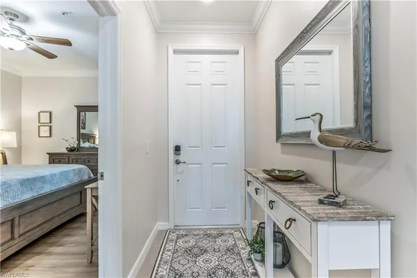 a living room with furniture kitchen and a chandelier