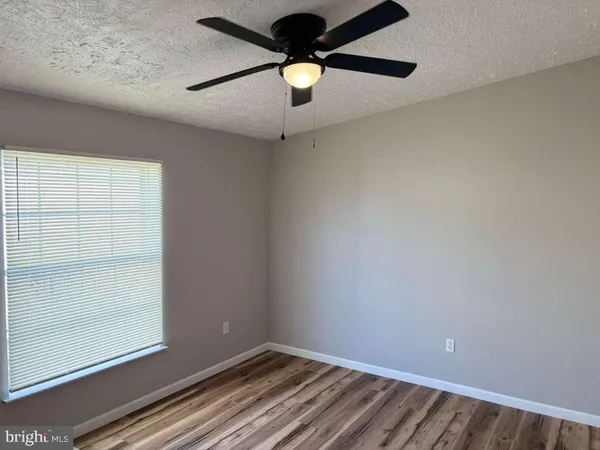a room with a ceiling fan and a window