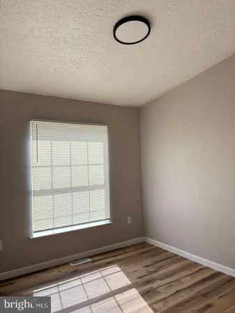 a view of walk in closet with wooden floor