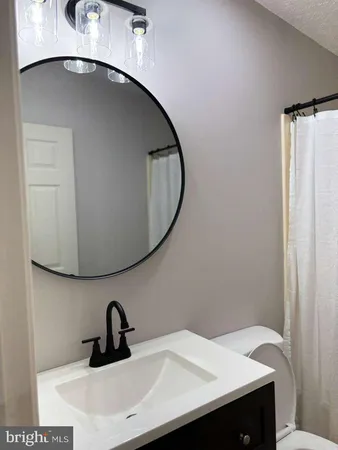 a bathroom with a toilet and a mirror