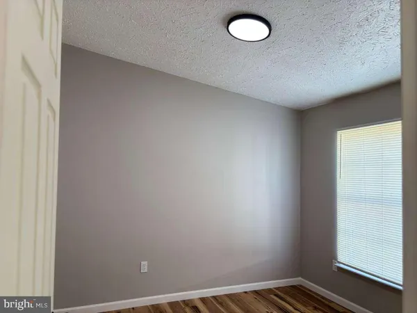 a view of a room with wooden floor and window