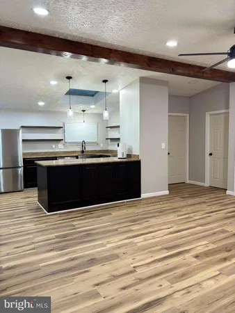 a kitchen with stainless steel appliances granite countertop a sink and a stove