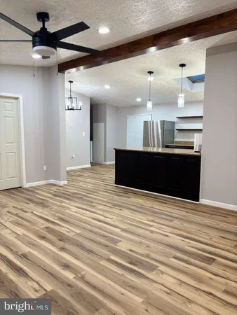 a view of kitchen and empty room