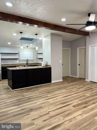 a kitchen with stainless steel appliances granite countertop a sink and cabinets