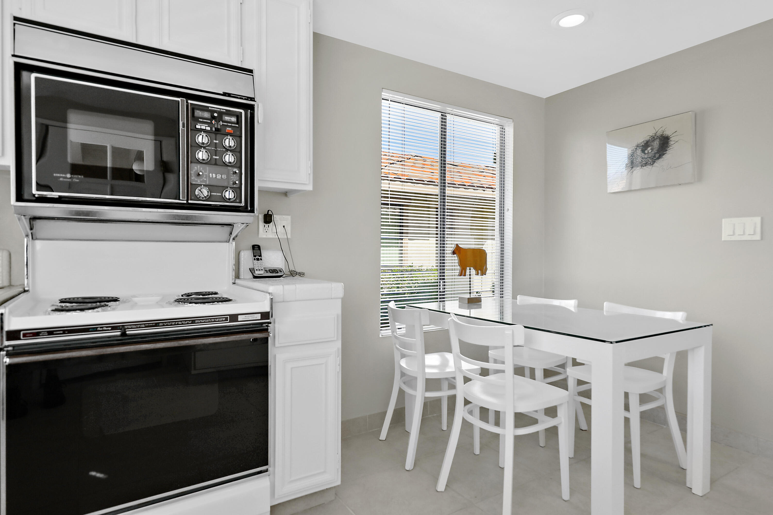 175 Gran Via Palm Desert, CA 92260 - Photo 13 of 36 a kitchen with a stove and chairs