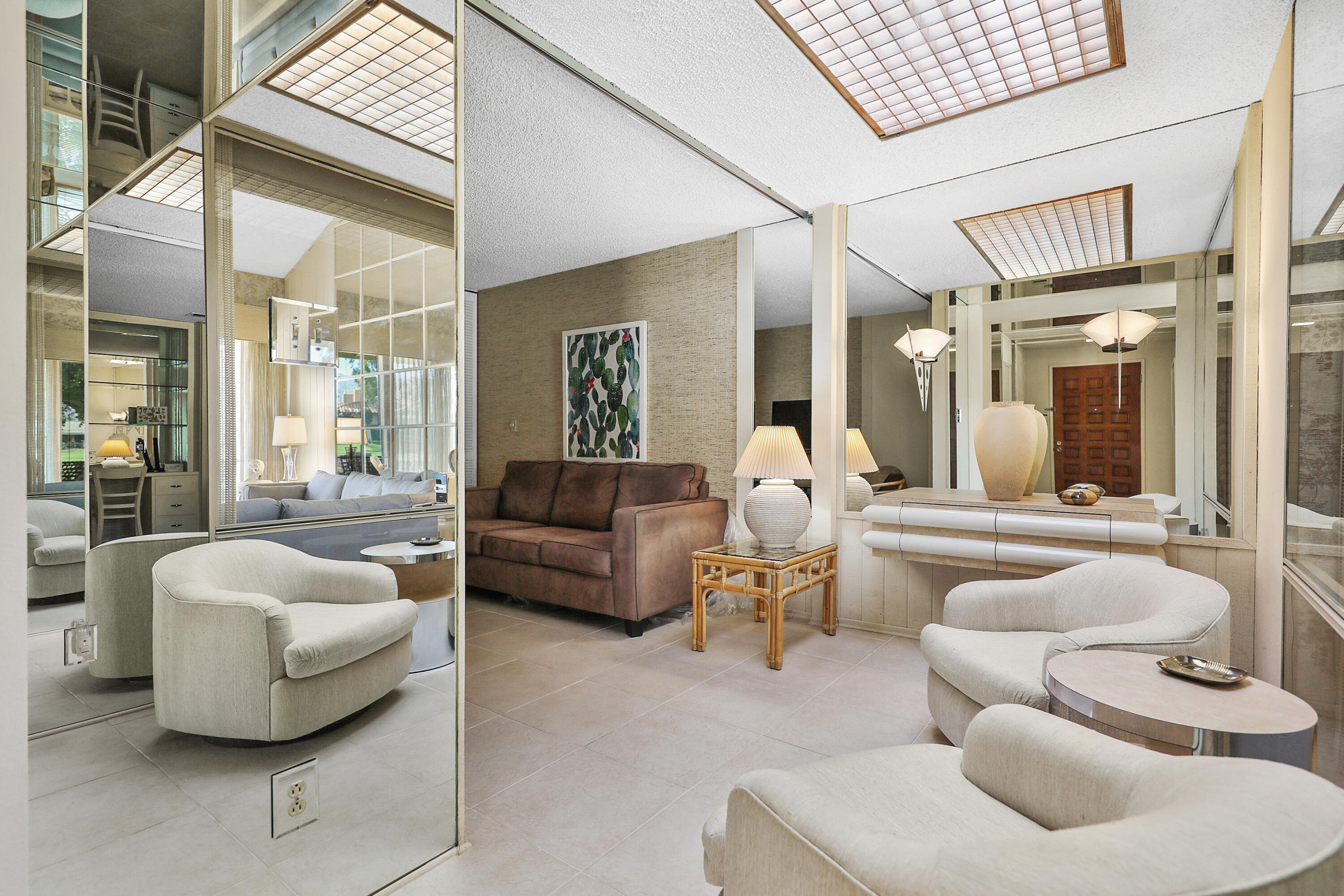 175 Gran Via Palm Desert, CA 92260 - Photo 14 of 36 a living room with furniture and a large window