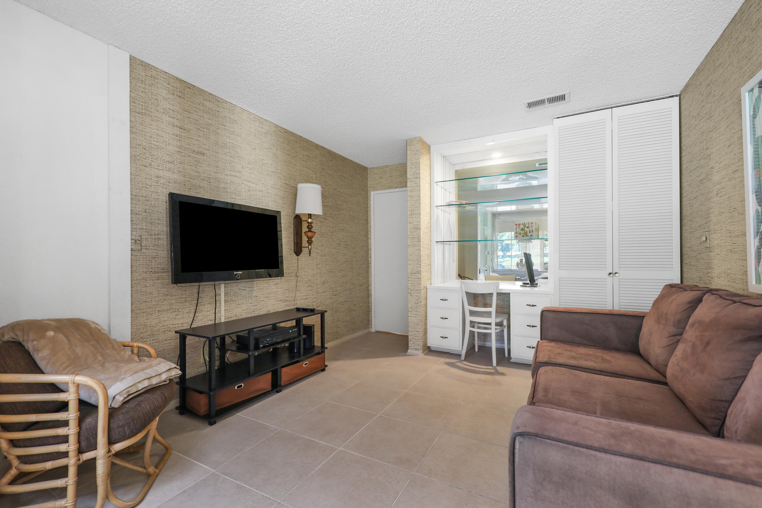175 Gran Via Palm Desert, CA 92260 - Photo 17 of 36 a living room with furniture and a flat screen tv