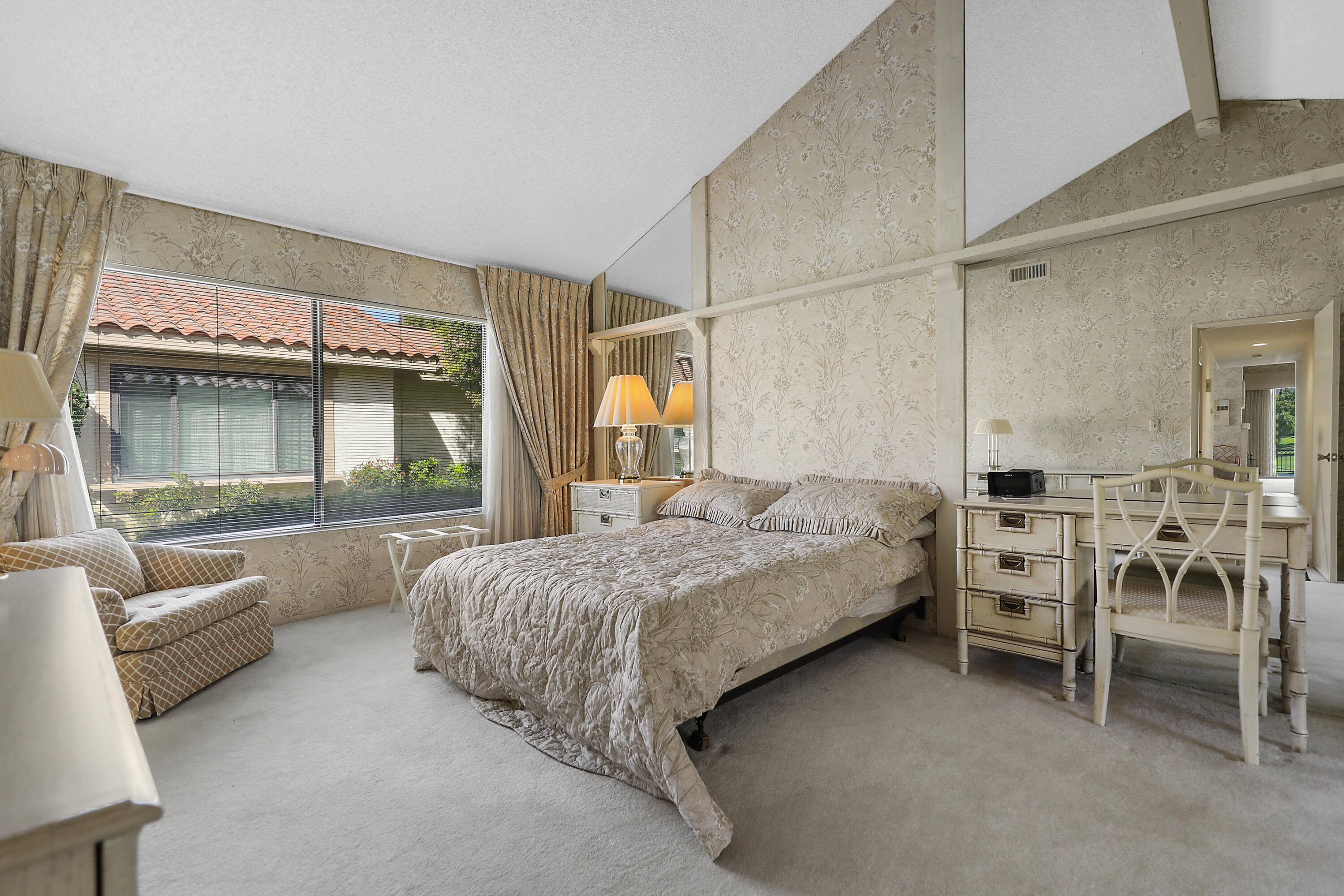 175 Gran Via Palm Desert, CA 92260 - Photo 20 of 36 a bedroom with furniture and a large window