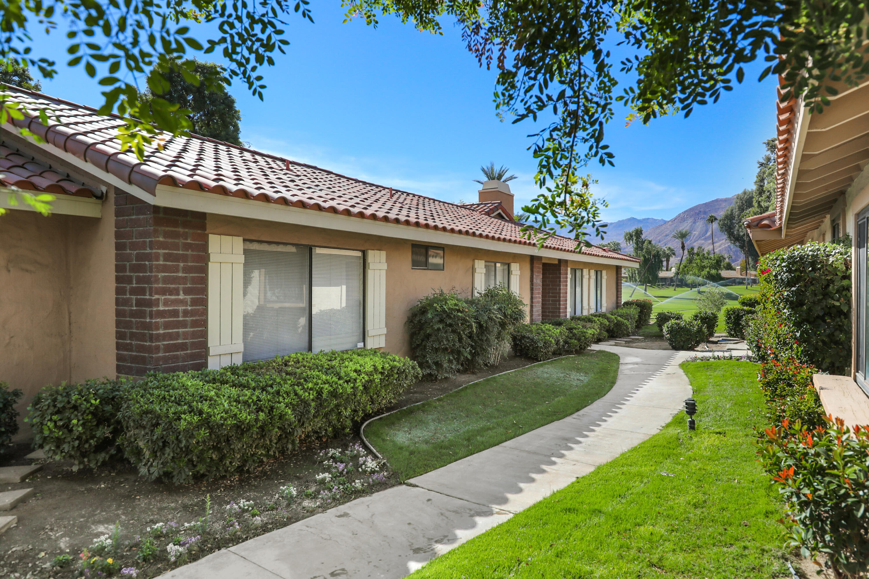 175 Gran Via Palm Desert, CA 92260 - Photo 2 of 36 a front view of a house with garden